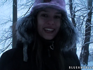 Fine european babe takes a walk through the woods during winter